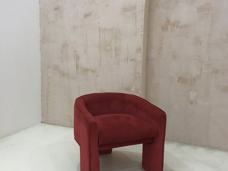 Minimalist room with a single chair and soft lighting